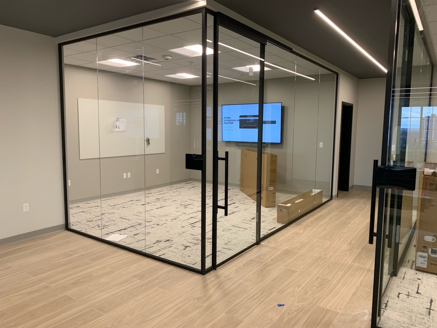 Modern commercial office with black-framed glass architectural wall installation