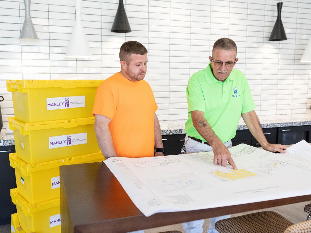 RDI – ReceiveDeliverInstall installation team coordinating a corporate move with detailed floor plans and Manley relocation bins for organized move management.